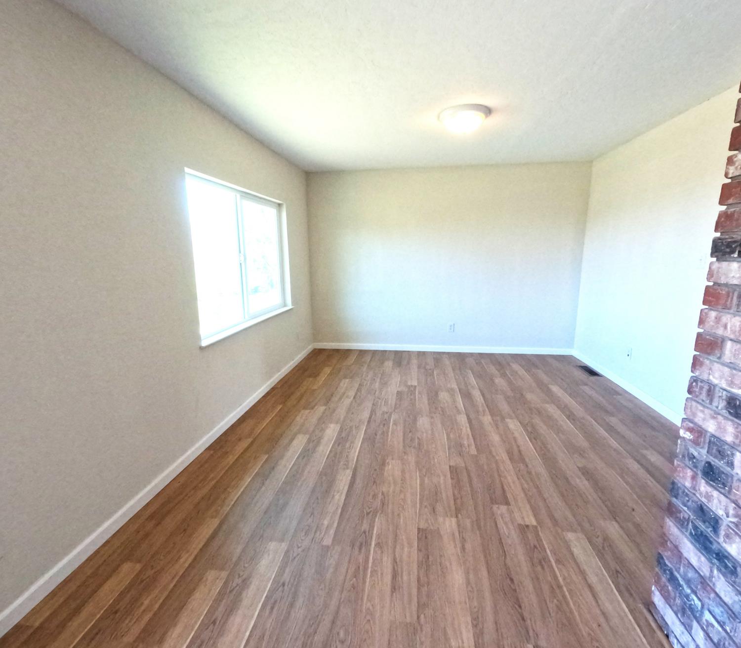 21665 Manton School Road Manton, CA 96059 - Photo 6 of 30 an empty room with wooden floor and windows