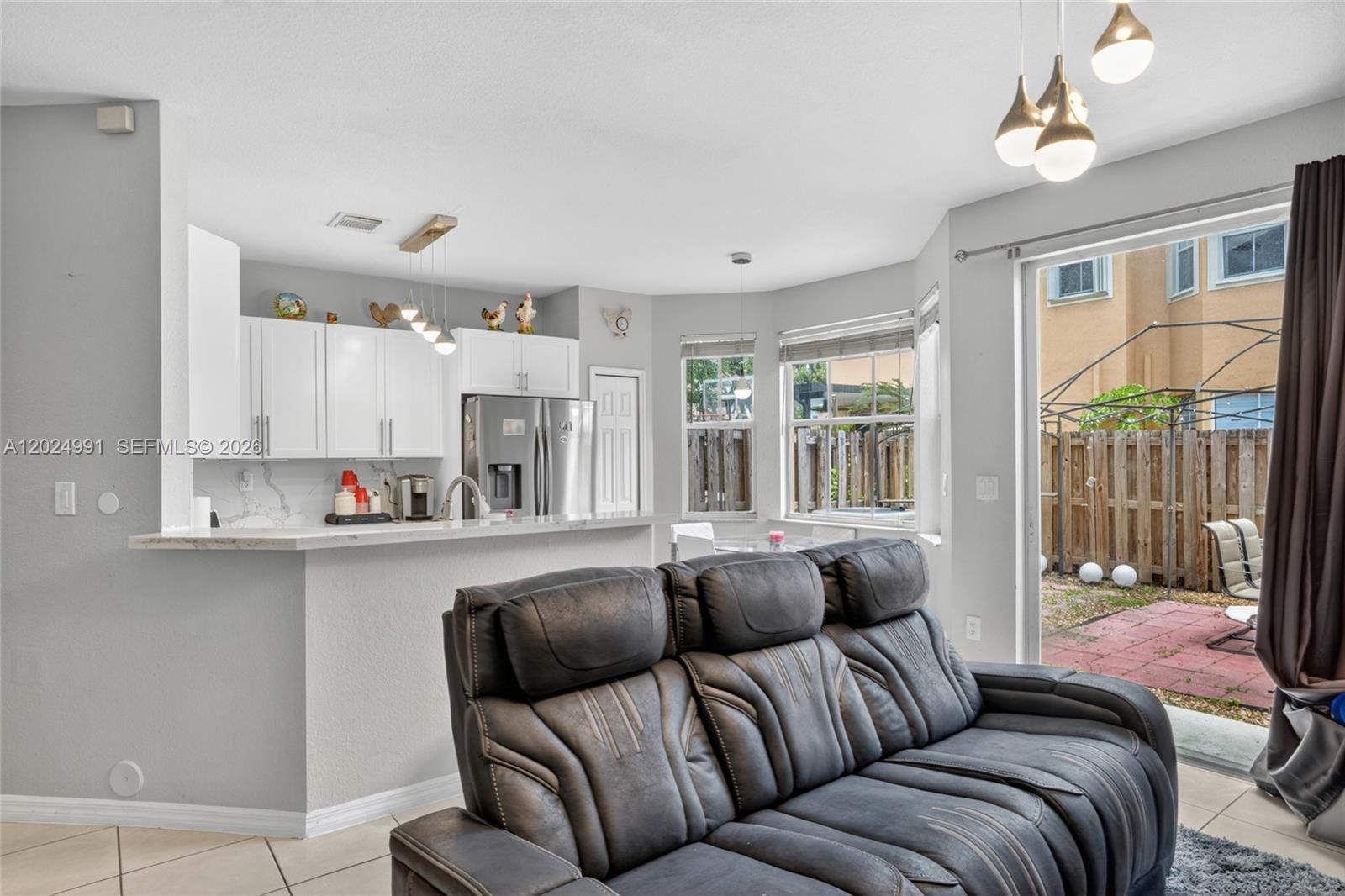 16651 Southwest 79th Terrace Miami, FL 33193 - Photo 10 of 34 a living room with furniture and a large window