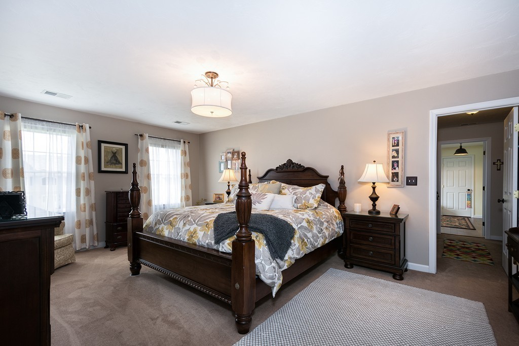 63 Saw Mill Road Duxbury, MA 02332 - Photo 18 of 29 a bedroom with a bed and a chandelier