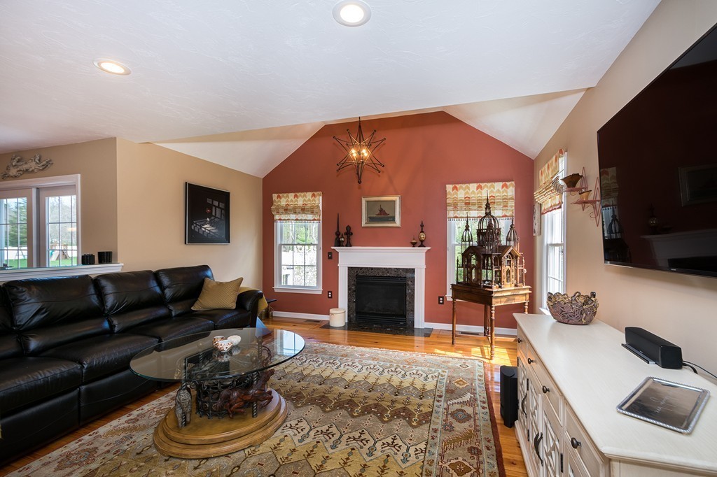 63 Saw Mill Road Duxbury, MA 02332 - Photo 5 of 29 a living room with furniture a flat screen tv and a fireplace