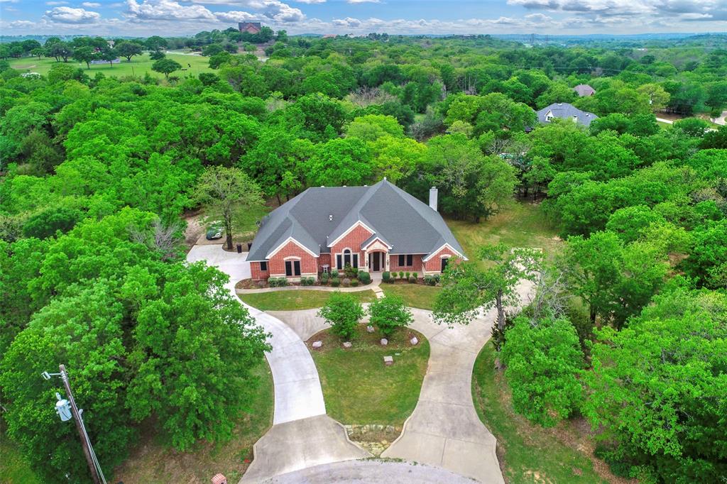 an aerial view of a house with a big yard