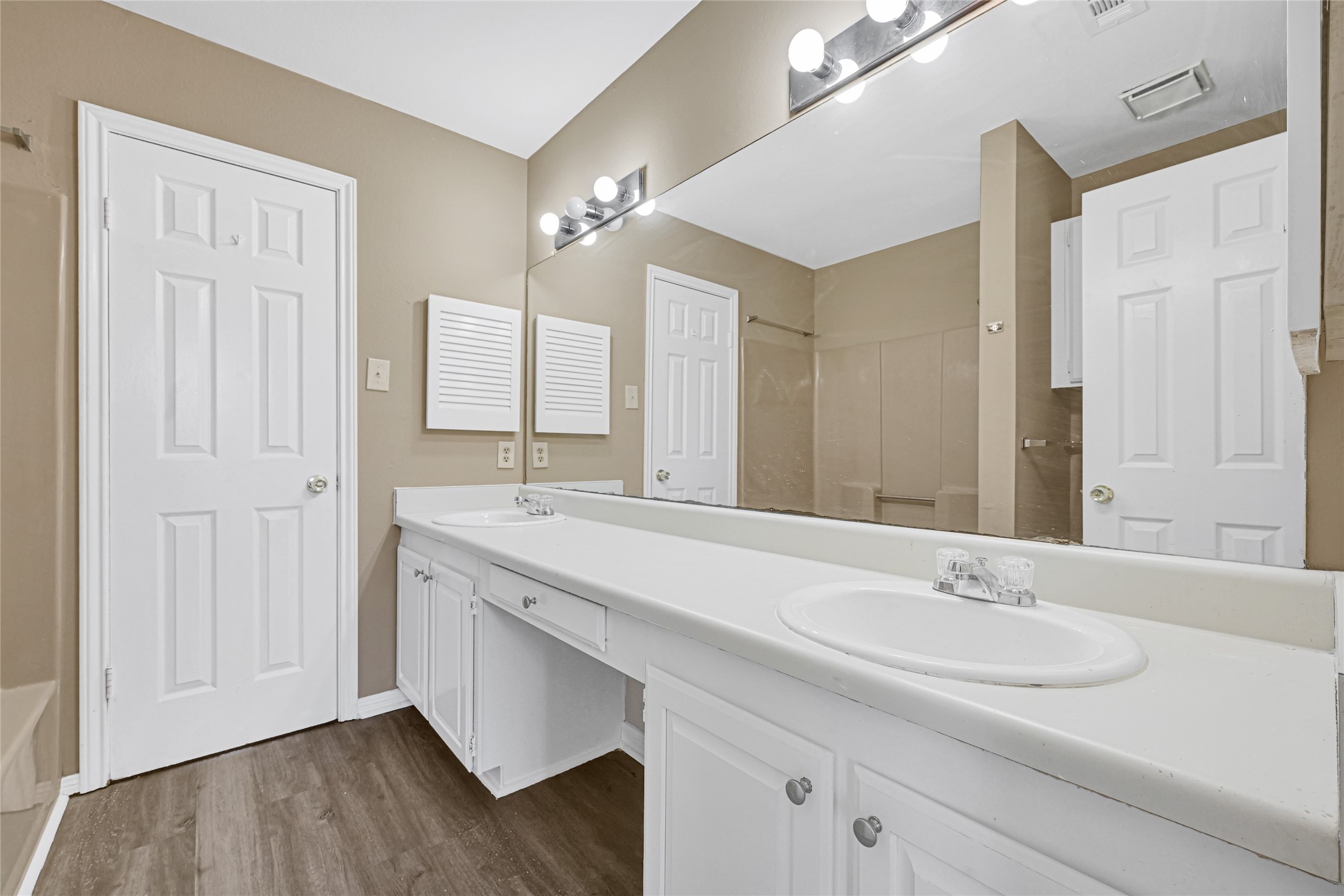 2030 Plantation Drive, Unit B14 Conroe, TX 77301 - Photo 12 of 19 a bathroom with a sink and a mirror