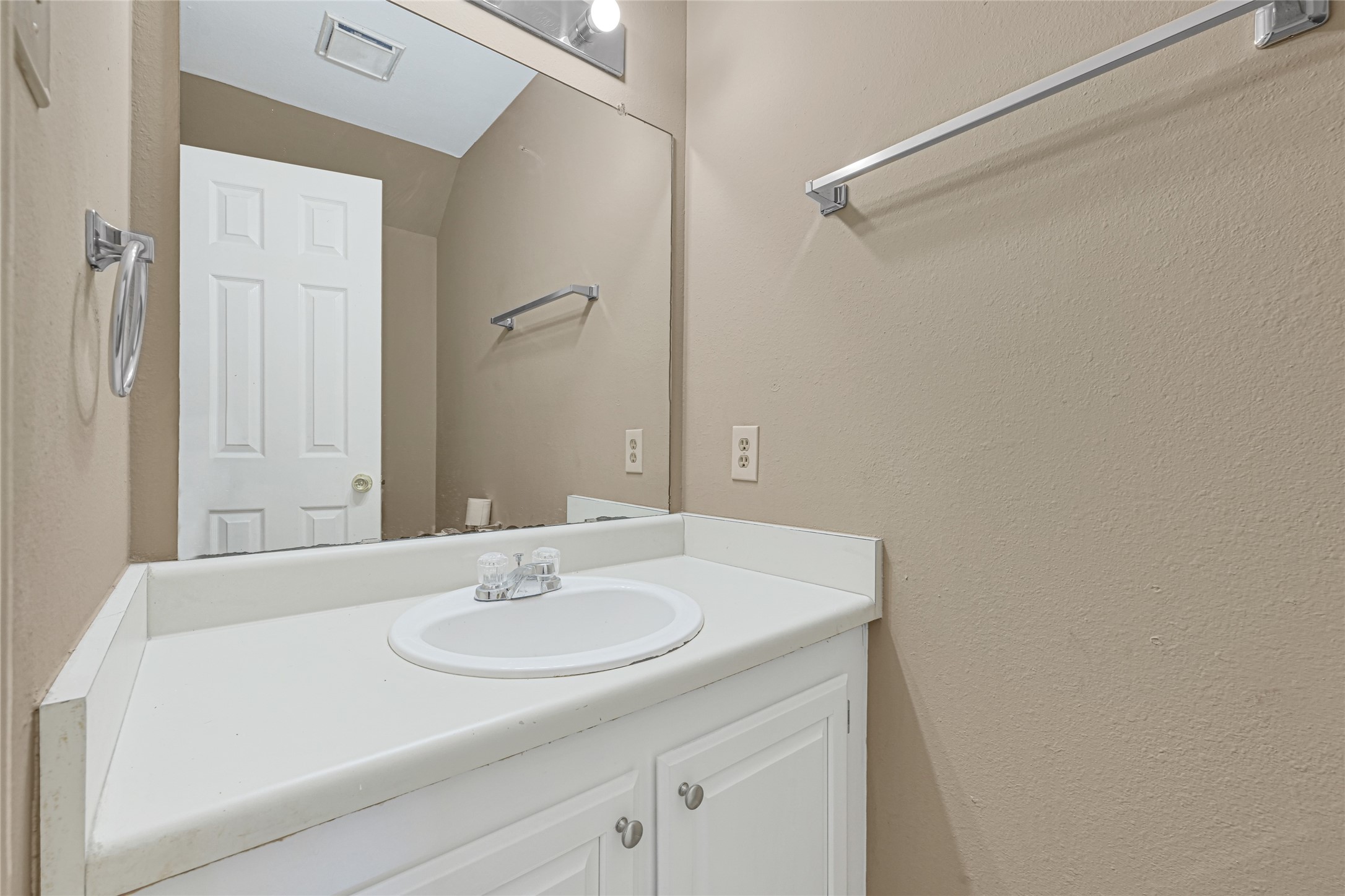 2030 Plantation Drive, Unit B14 Conroe, TX 77301 - Photo 15 of 19 a bathroom with a sink and a mirror