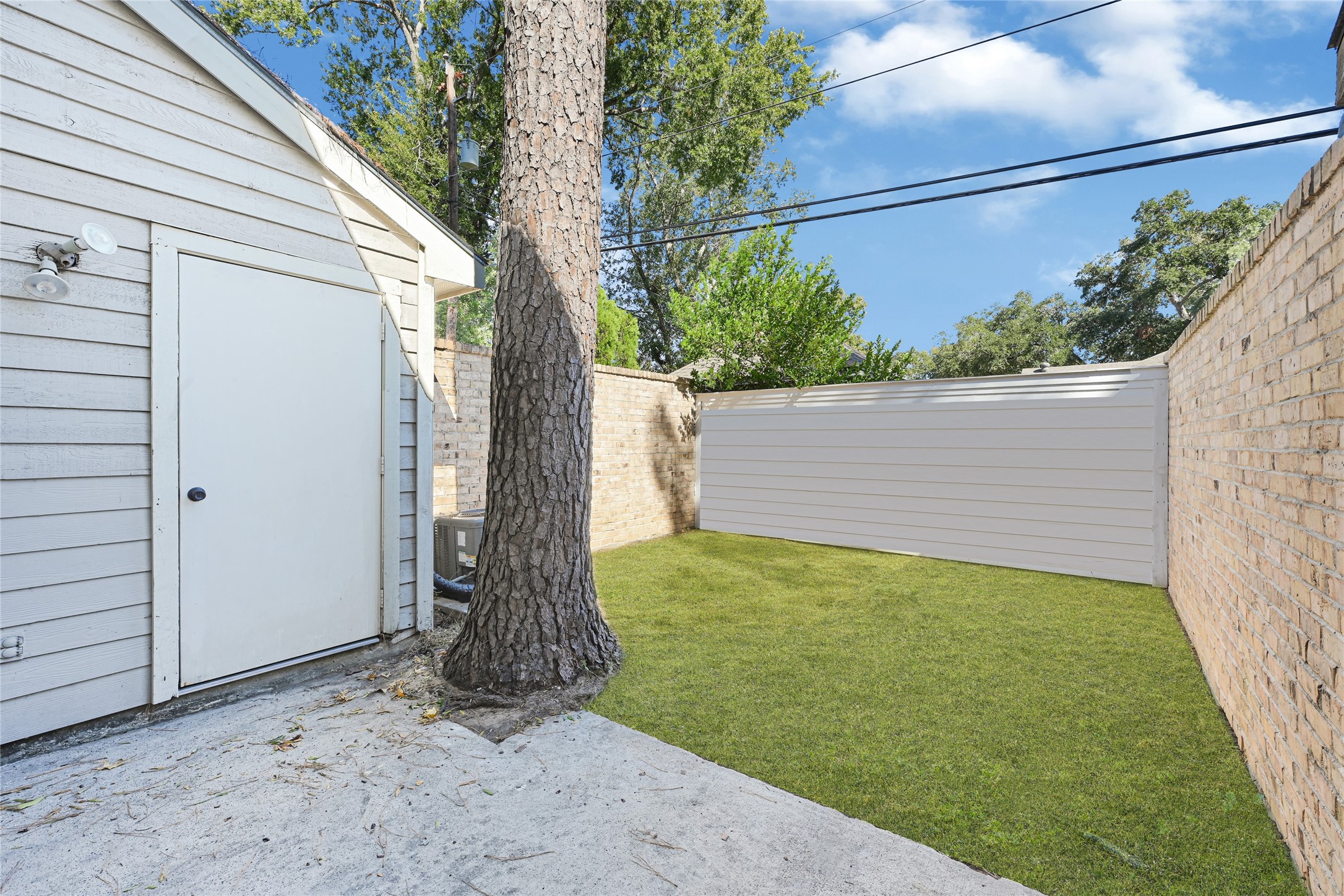 2030 Plantation Drive, Unit B14 Conroe, TX 77301 - Photo 17 of 19 a view of a backyard with a tree