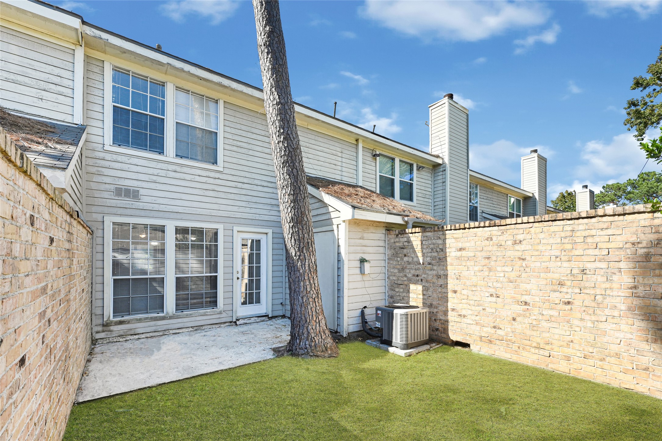 2030 Plantation Drive, Unit B14 Conroe, TX 77301 - Photo 19 of 19 a view of front of a house with a yard
