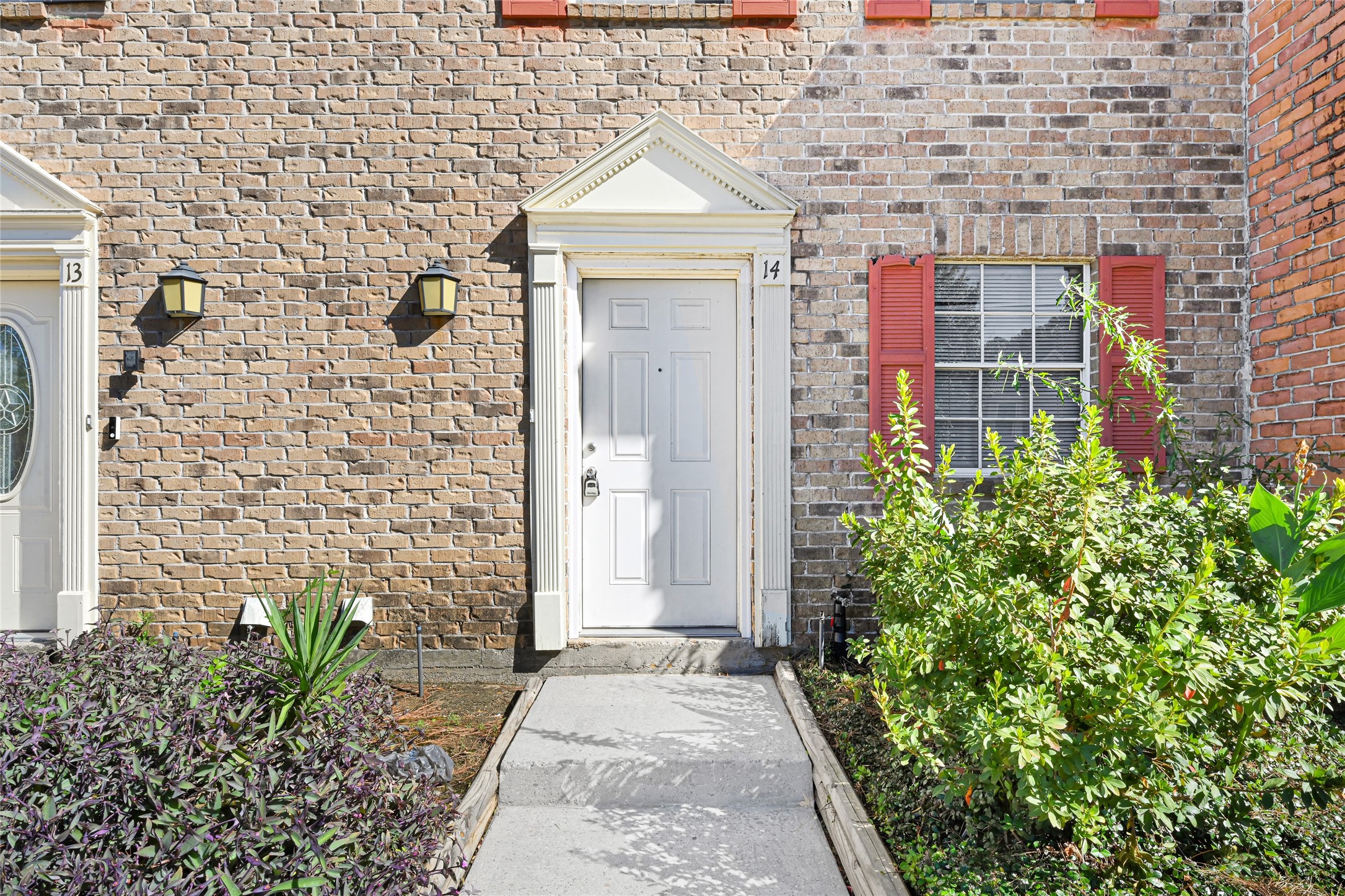 2030 Plantation Drive, Unit B14 Conroe, TX 77301 - Photo 2 of 19 a view of a pathway along a building