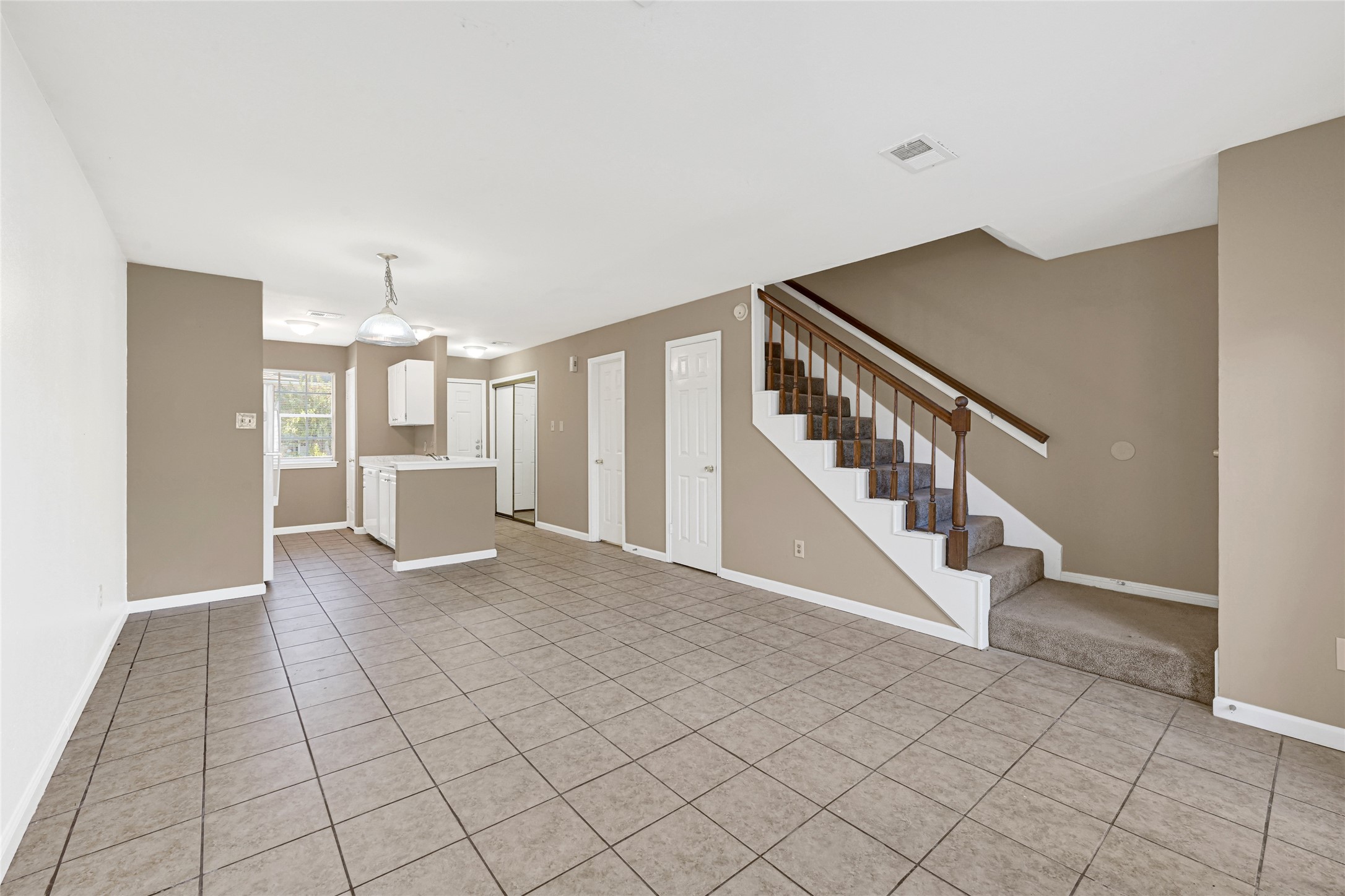 2030 Plantation Drive, Unit B14 Conroe, TX 77301 - Photo 4 of 19 a view of entryway with stairs and wooden floor