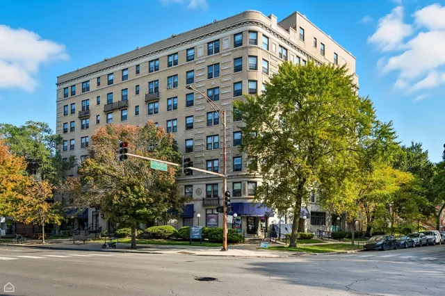 a view of a tall building next to a road