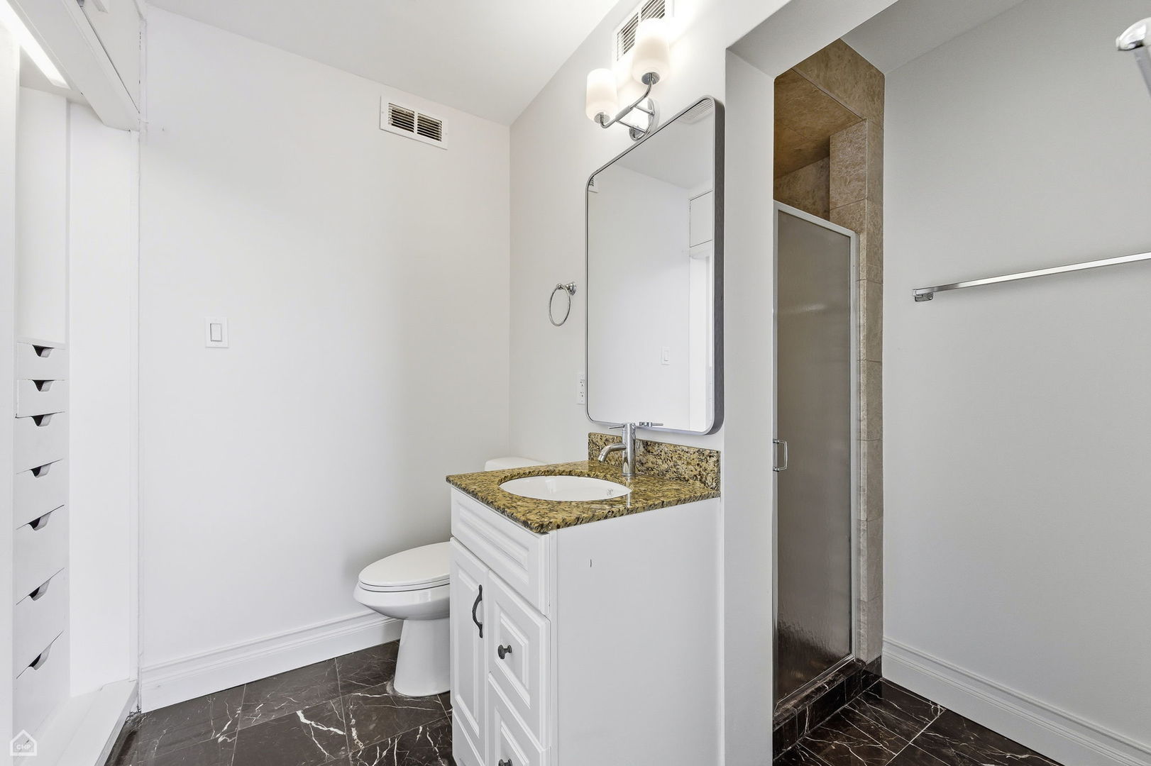 7301 North Sheridan Road, Unit 901 Chicago, IL 60626 - Photo 14 of 18 a bathroom with a granite countertop sink toilet and shower