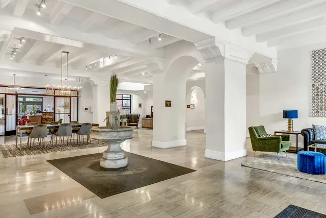 a living room with lots of furniture and a chandelier