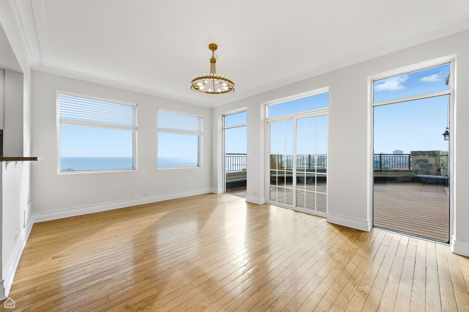 7301 North Sheridan Road, Unit 901 Chicago, IL 60626 - Photo 3 of 18 a view of an empty room with window and wooden floor