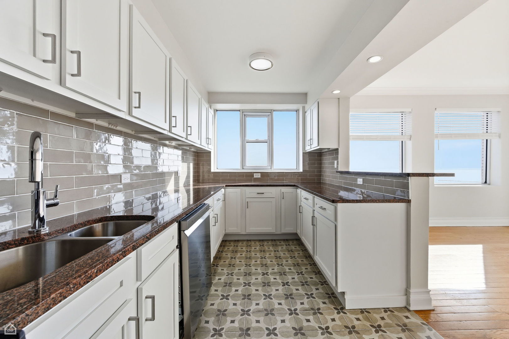 7301 North Sheridan Road, Unit 901 Chicago, IL 60626 - Photo 4 of 18 a large white kitchen with a sink and cabinets