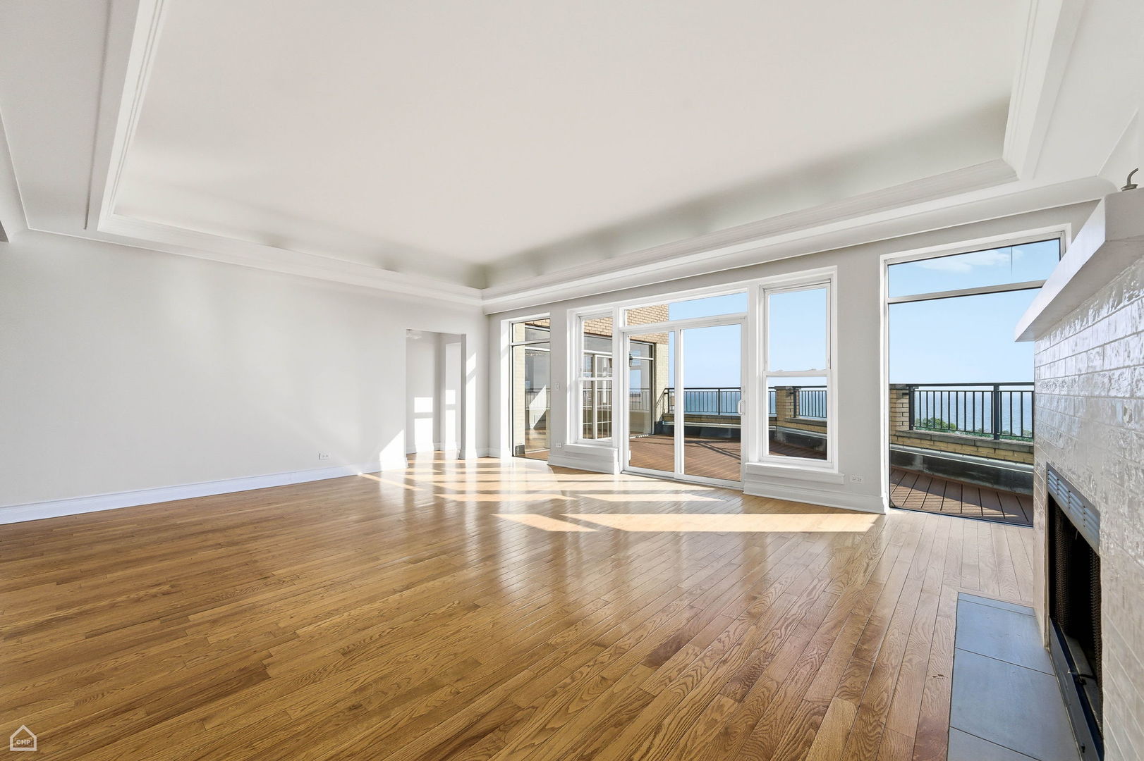 7301 North Sheridan Road, Unit 901 Chicago, IL 60626 - Photo 10 of 18 a view of empty room with wooden floor and fireplace
