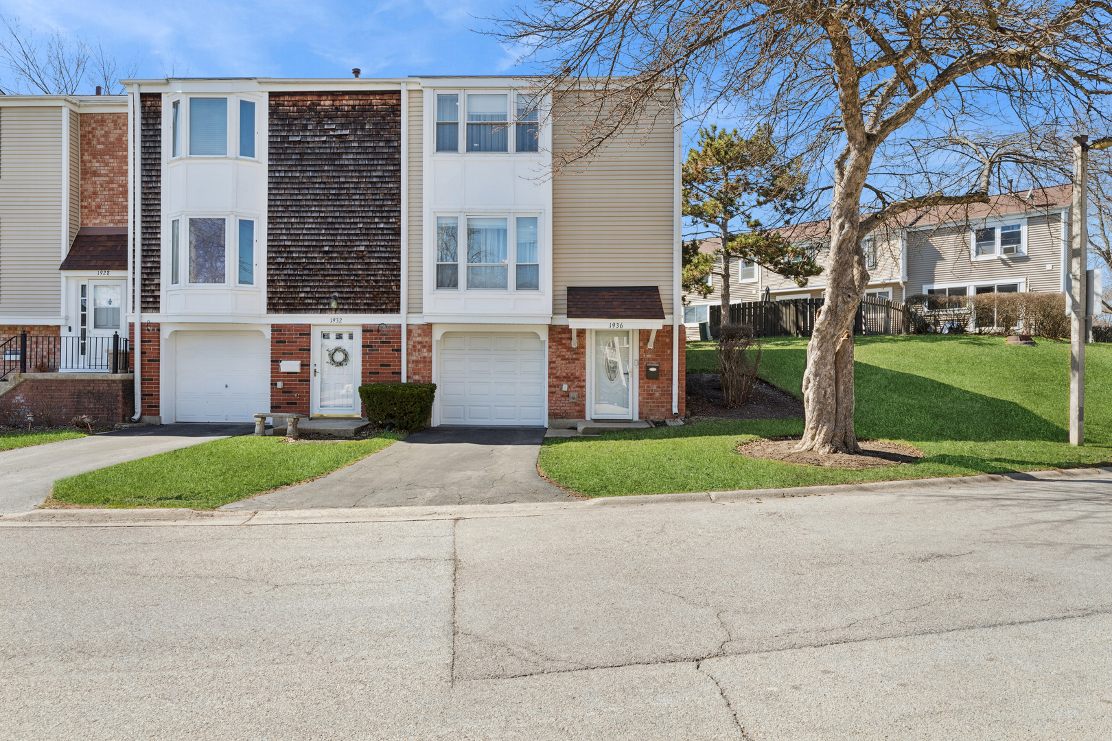 1936 Whitingham Lane Hoffman Estates, IL 60169 - Photo 2 of 23 a front view of a house with a yard and garage