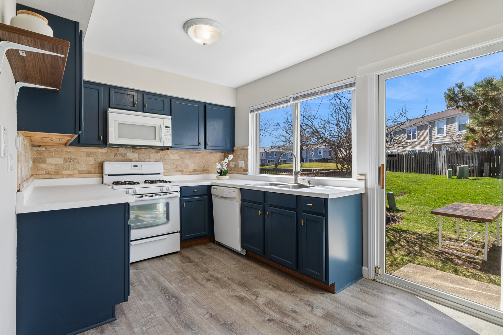 1936 Whitingham Lane Hoffman Estates, IL 60169 - Photo 10 of 23 a kitchen with a sink stove and cabinets