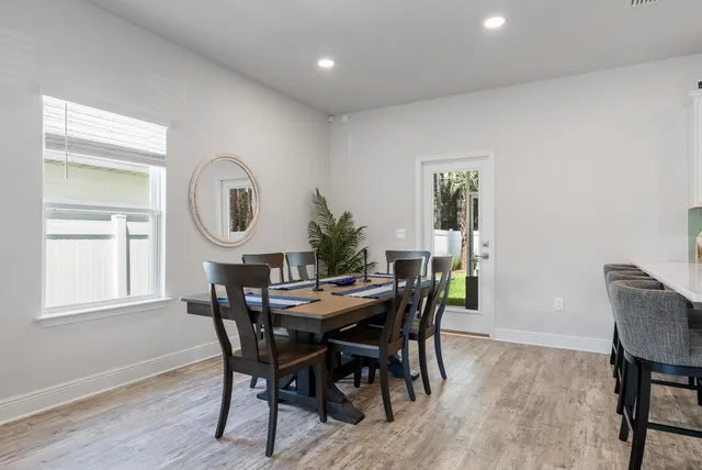 a view of a dining room with furniture and a window