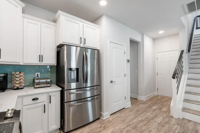 a kitchen with stainless steel appliances a refrigerator and cabinets