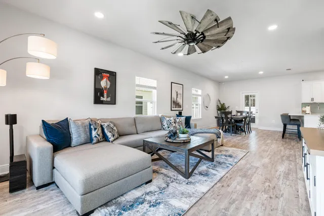a living room with furniture a view of bedroom and a window