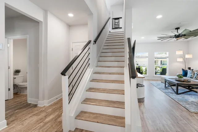 a room with pool table and windows
