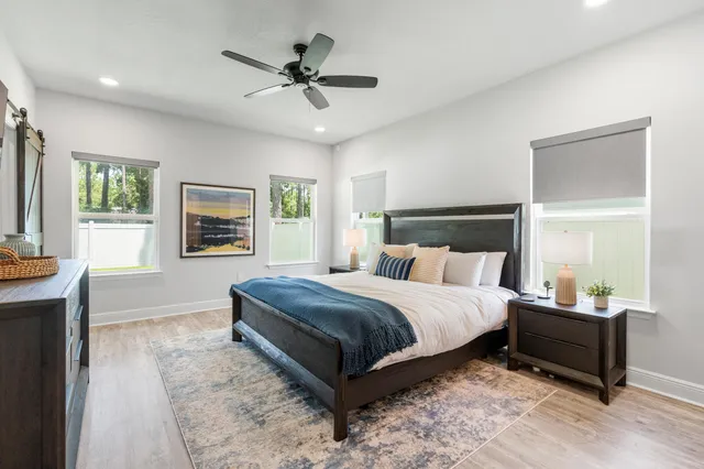 a large bedroom with a bed and a chandelier