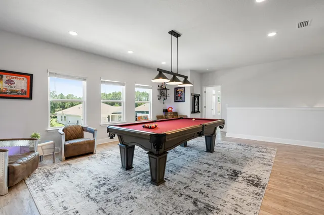 a view of a livingroom with a hardwood floor and a ceiling fan