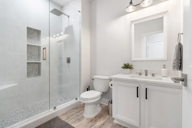 an empty room with a window and a ceiling fan