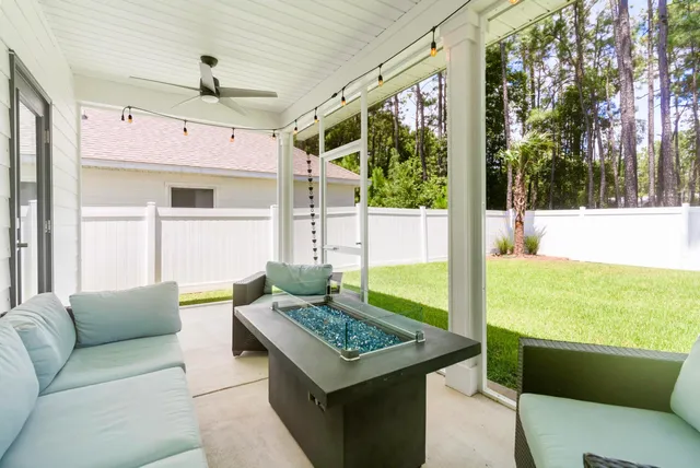 a view of yard with swimming pool and trees in the background