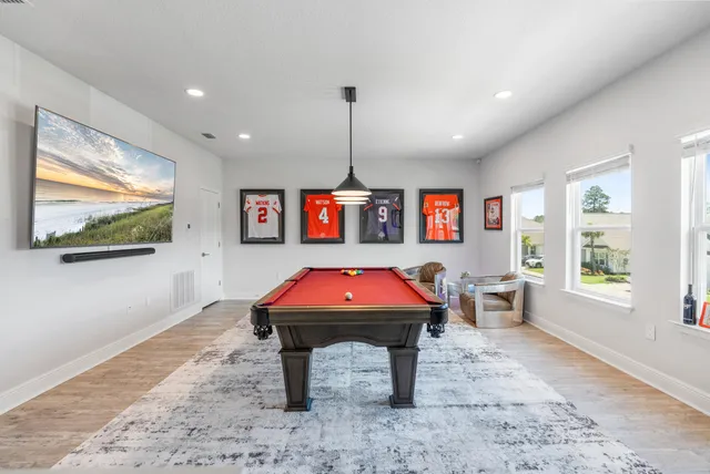 a living room with pool table and a flat screen tv