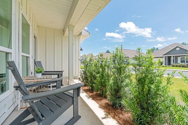 a view of balcony with wooden floor and outdoor seating