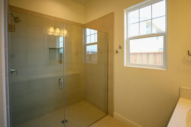 a bathroom with a glass shower door