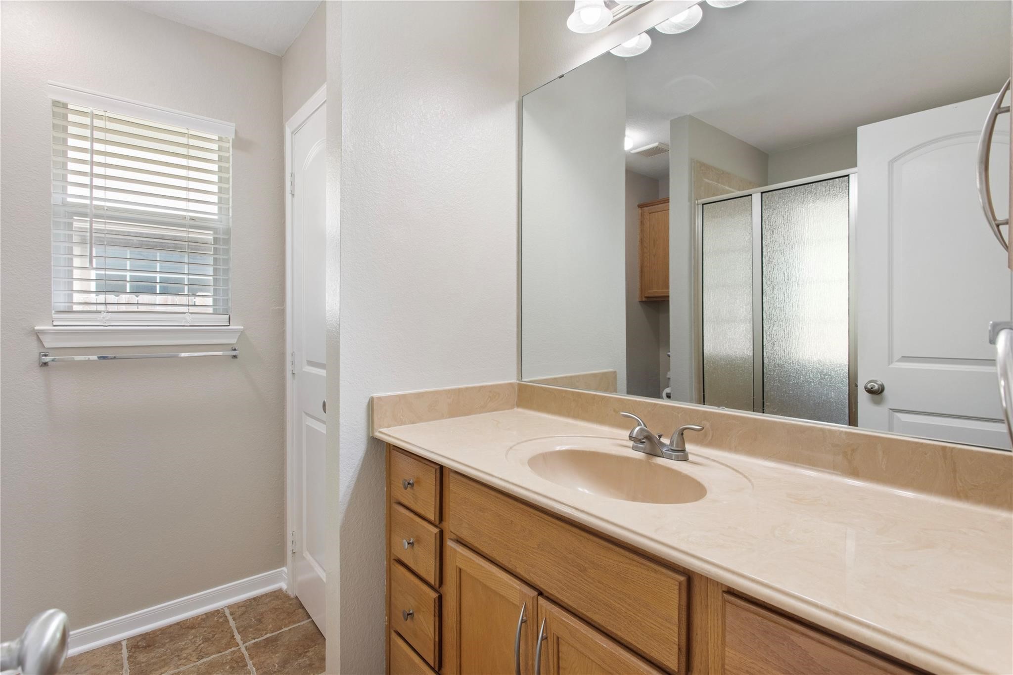 2023 Mountain Wind Loop Bryan, TX 77807 - Photo 11 of 16 a bathroom with a sink and a mirror
