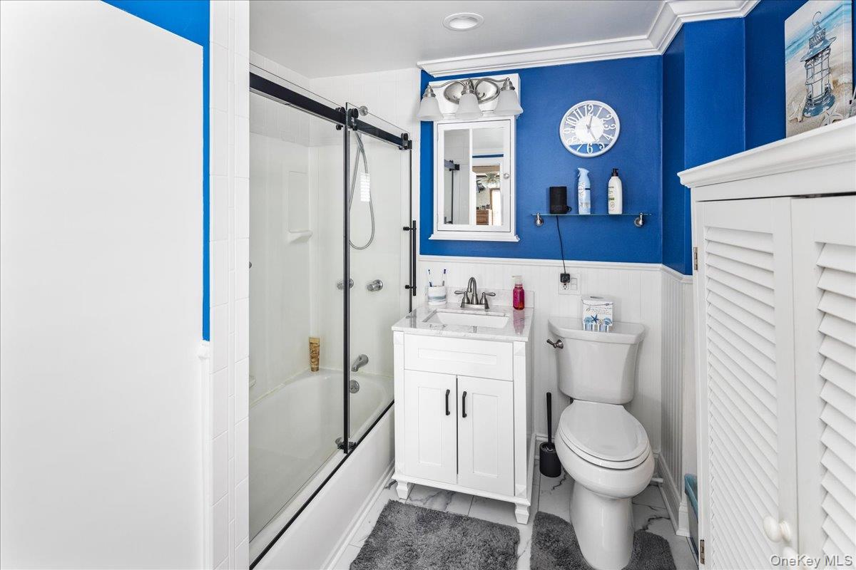 170 Birch Hill Road Locust Valley, NY 11560 - Photo 18 of 38 a bathroom with a toilet sink vanity and mirror