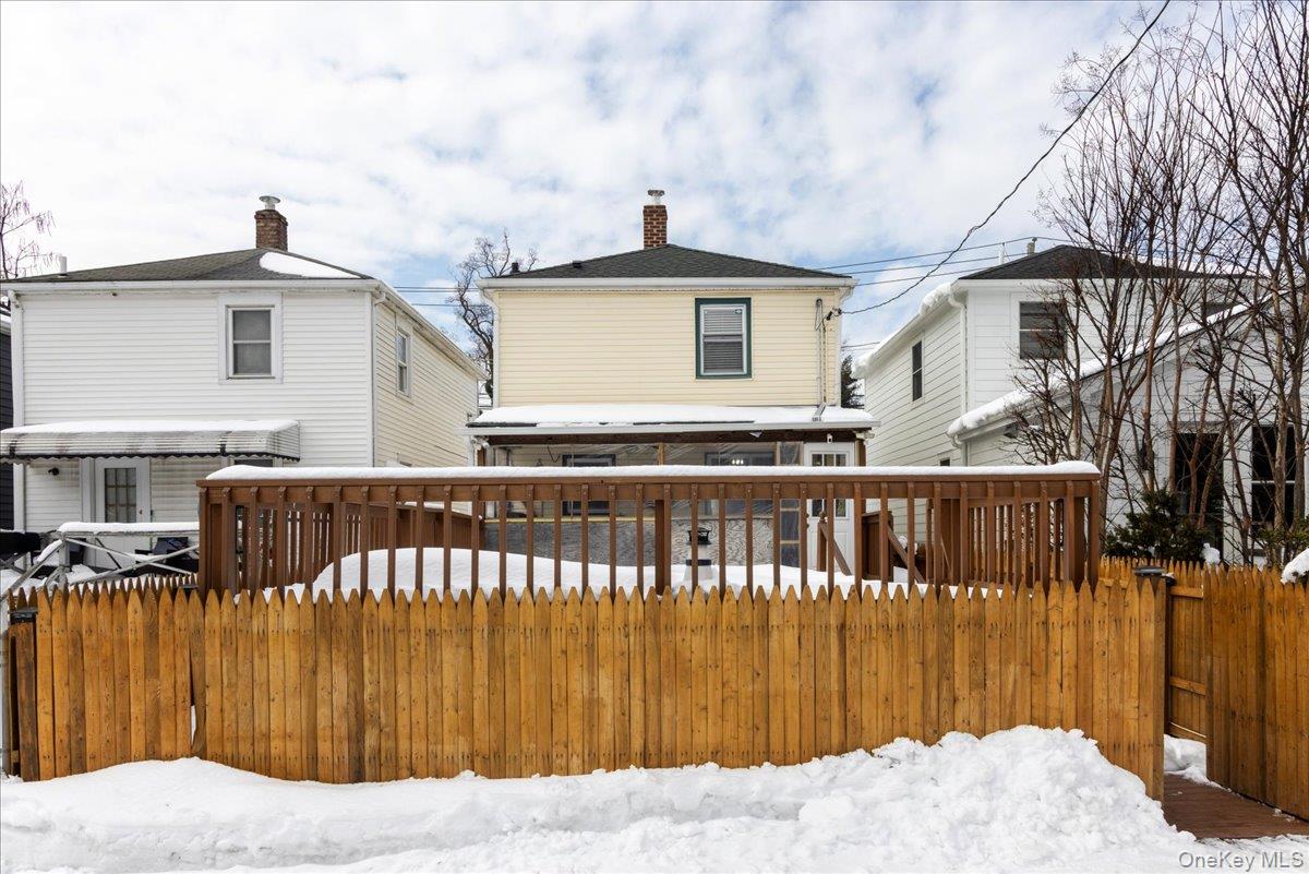 170 Birch Hill Road Locust Valley, NY 11560 - Photo 25 of 38 a front view of a house with a wooden fence