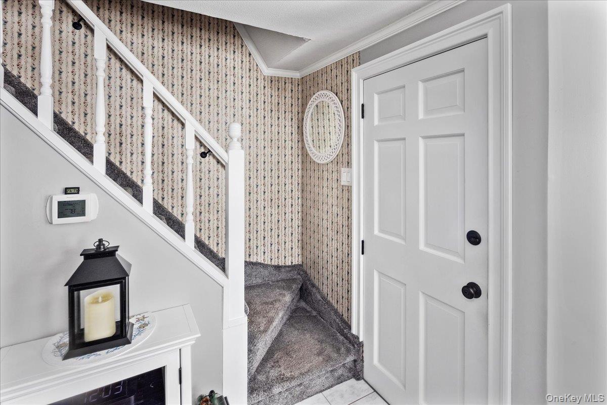 170 Birch Hill Road Locust Valley, NY 11560 - Photo 6 of 38 a view of a hallway with entryway wooden floor and front door