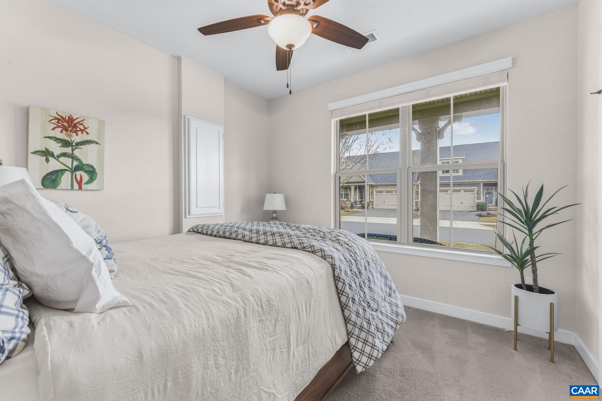 360 Winding Road Keswick, VA 22947 - Photo 33 of 48 a bedroom with a large bed and a large window