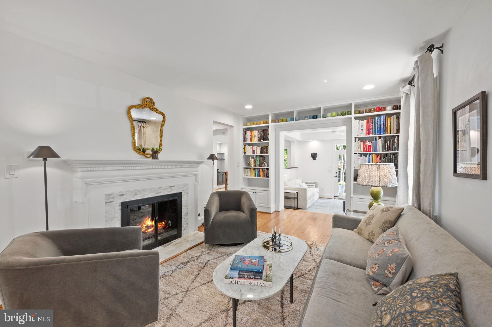 7409 Ridgewood Avenue Chevy Chase, MD 20815 - Photo 5 of 29 Living room with fireplace & bookshelves
