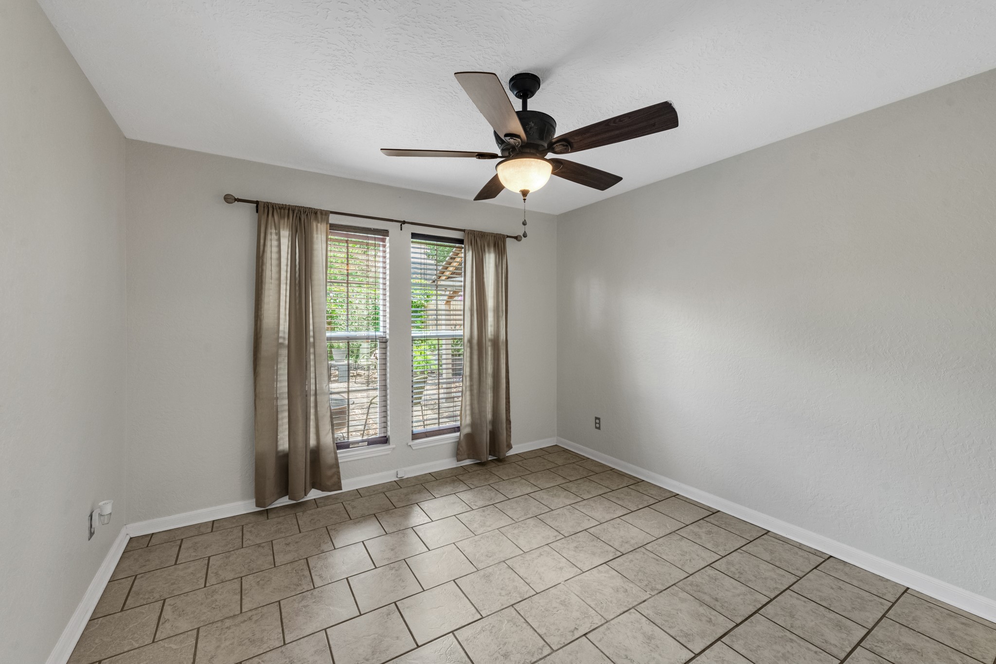 622 South Rivershire Drive Conroe, TX 77304 - Photo 37 of 44 an empty room with windows and fan