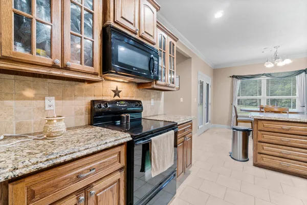 a kitchen with stainless steel appliances granite countertop a sink and a microwave