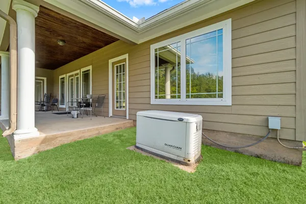 a view of a house with backyard porch and sitting area