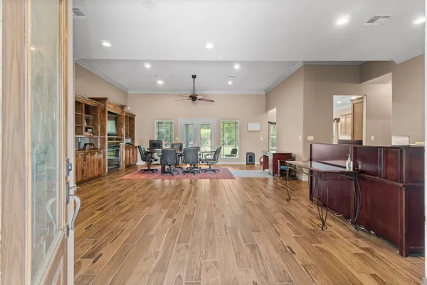 a living room with furniture and wooden floor