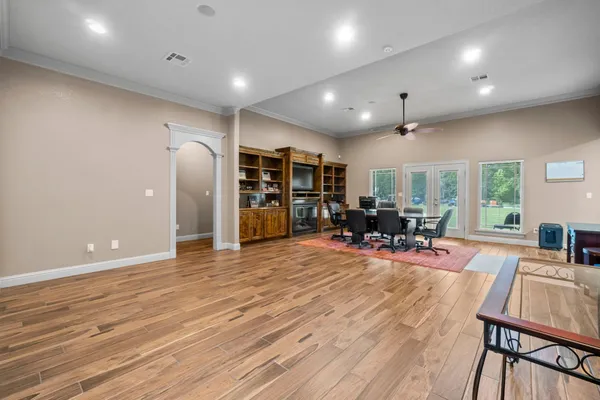 an empty room with wooden floor and furniture