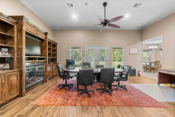 a living room with furniture a large window and stainless steel appliances