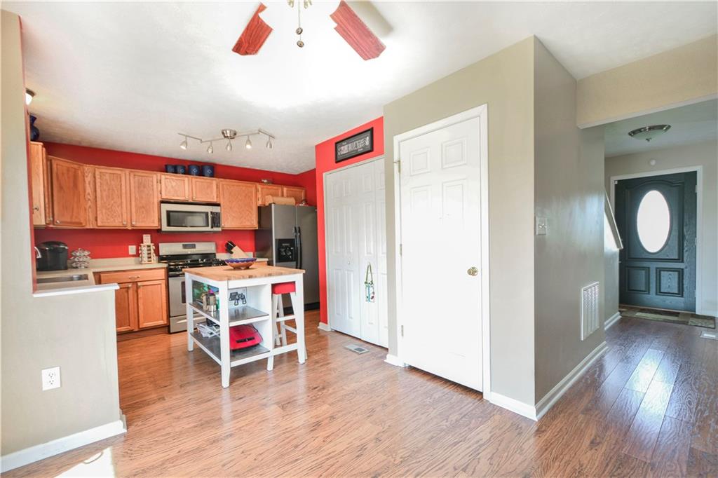 Wood laminate flooring abounds through first floor Kitchen, Dining Room, Entry and Hallway - makes for ease in cleaning for the busy household!
