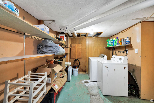 667 North 100 East Logan, UT 84321 - Photo 41 of 41 Apartment Laundry area featuring washing machine and clothes dryer, concrete flooring, and wood walls