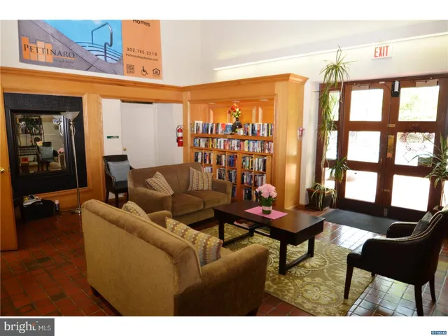 a kitchen with a refrigerator sink and cabinets