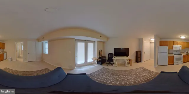 a kitchen with a sink a refrigerator and cabinets