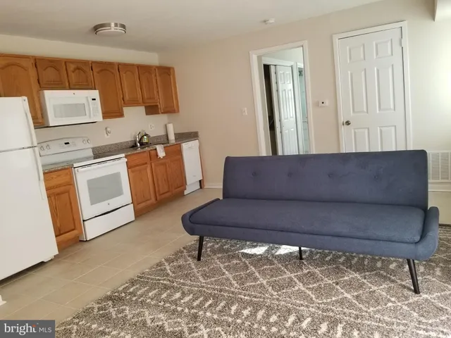 a kitchen with a refrigerator sink and cabinets
