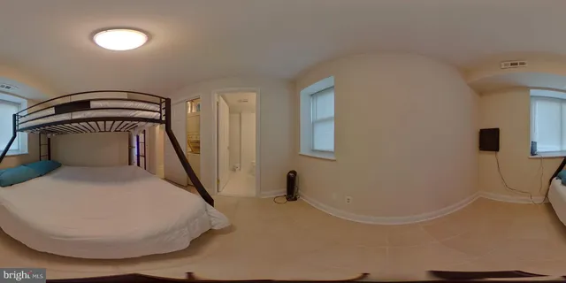 a spacious bathroom with a granite countertop sink a mirror and bathtub