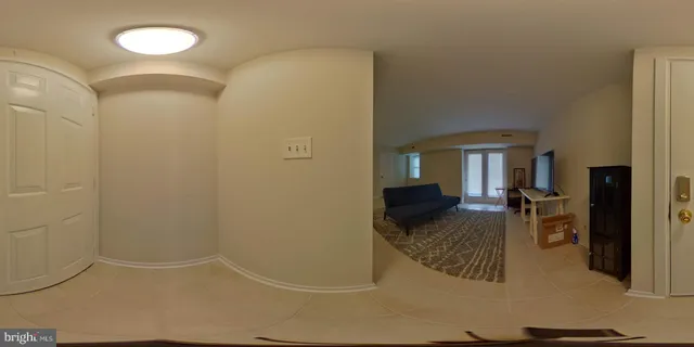 a living room with furniture a fireplace and large windows
