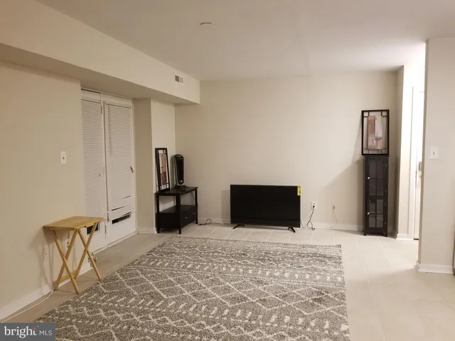 a spacious bathroom with a sink a toilet a mirror and shower